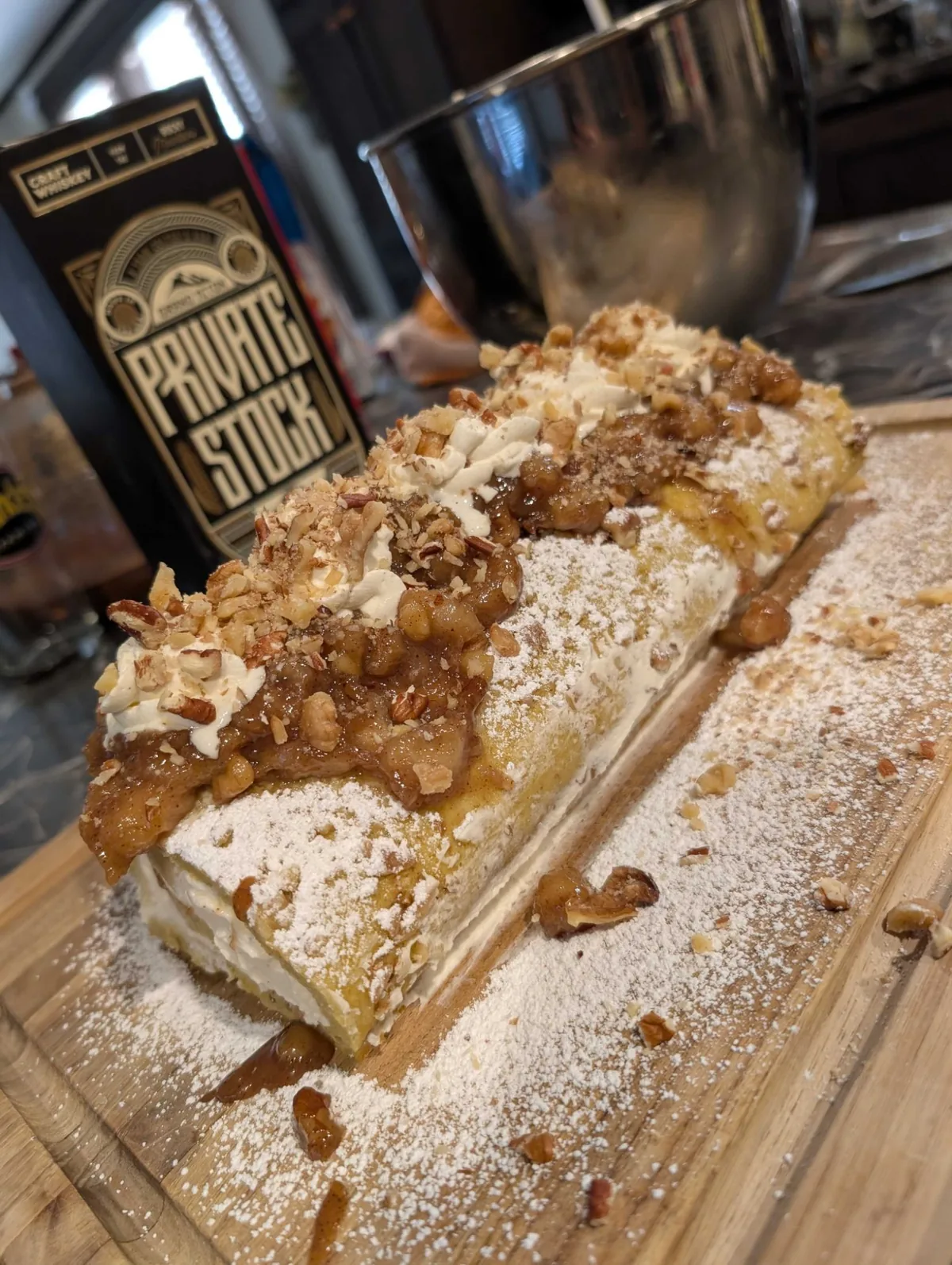 Looking down the length of the roll at the caramel bananas, cream rosettes and candied pecans along the top